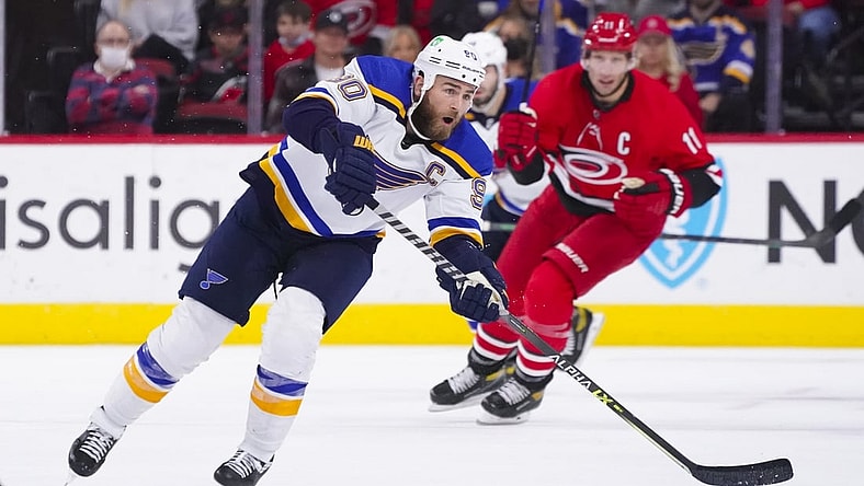 Nov 13, 2021; Raleigh, North Carolina, USA;  St. Louis Blues center Ryan O'Reilly (90) passes the puck during the second period against the Carolina Hurricanes at PNC Arena. Mandatory Credit: James Guillory-USA TODAY Sports