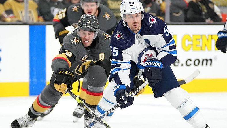 Jan 2, 2022; Las Vegas, Nevada, USA; Vegas Golden Knights defenseman Brayden McNabb (3) reaches to poke the puck away from Winnipeg Jets center Mark Scheifele (55) during the third period at T-Mobile Arena. Mandatory Credit: Stephen R. Sylvanie-USA TODAY Sports