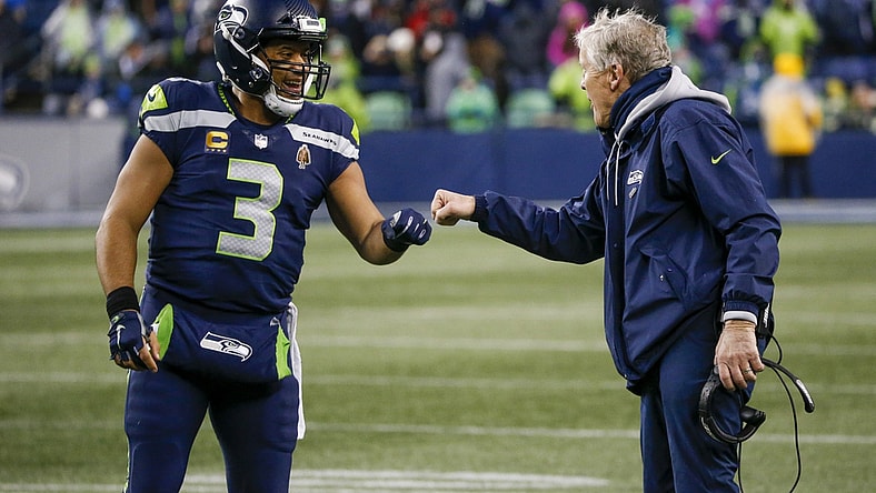 Jan 2, 2022; Seattle, Washington, USA; Seattle Seahawks quarterback Russell Wilson (3) bumps fists with head coach Pete Carroll during the fourth quarter two-minute warning against the Detroit Lions at Lumen Field. Mandatory Credit: Joe Nicholson-USA TODAY Sports