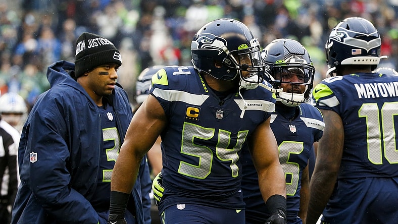 Jan 2, 2022; Seattle, Washington, USA; Seattle Seahawks middle linebacker Bobby Wagner (54) is assisted to the sideline by free safety Quandre Diggs (6) following an injury against the Detroit Lions during the first quarter at Lumen Field. Seattle Seahawks quarterback Russell Wilson (3) follows behind Wagner and Diggs. Mandatory Credit: Joe Nicholson-USA TODAY Sports
