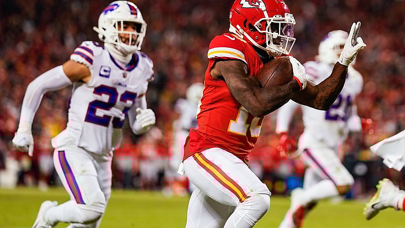 Jan 23, 2022; Kansas City, Missouri, USA; Kansas City Chiefs wide receiver Tyreek Hill (10) runs the ball for a touchdown past Buffalo Bills safety Micah Hyde (23) during the second half in a AFC Divisional playoff football game at GEHA Field at Arrowhead Stadium. Mandatory Credit: Jay Biggerstaff-USA TODAY Sports
