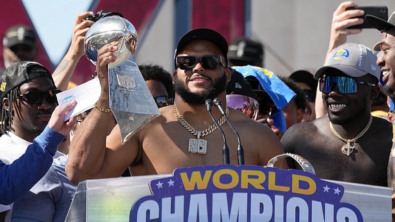 Feb 16, 2022; Los Angeles, CA, USA; Los Angeles Rams defensive end Aaron Donald holds the Vince Lombardi trophy during the Super Bowl LVI championship rally at the Los Angeles Memorial Coliseum. Mandatory Credit: Kirby Lee-USA TODAY Sports