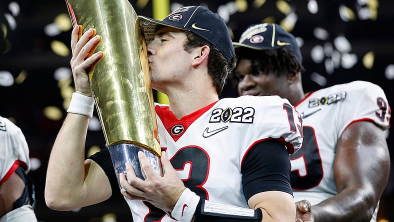 Georgia quarterback Stetson Bennett (13) kisses the trophy after winning the College Football Playoff National Championship on Jan. 10 at Lucas Oil Stadium in Indianapolis.

jump