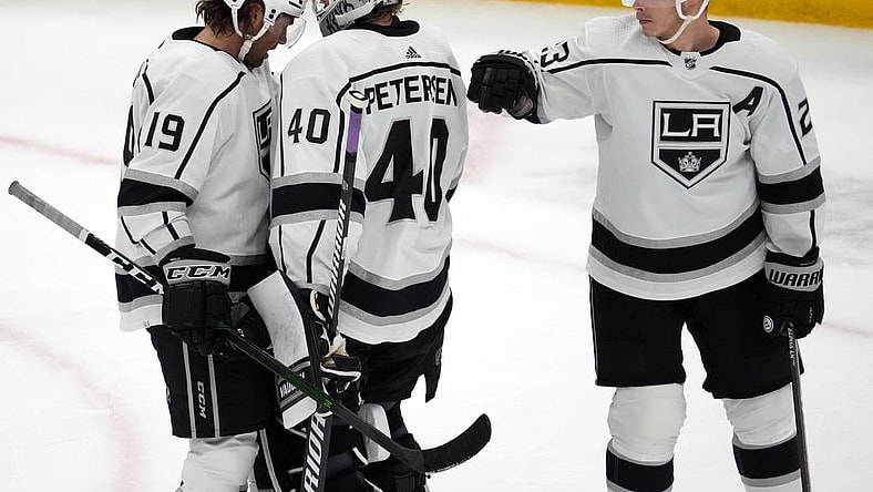 Feb 23, 2022; Glendale, Arizona, USA; Los Angeles Kings left wing Alex Iafallo (19) and Los Angeles Kings goaltender Cal Petersen (40) and Los Angeles Kings right wing Dustin Brown (23) celebrate after the third period against the Arizona Coyotes at Gila River Arena. Mandatory Credit: Joe Camporeale-USA TODAY Sports