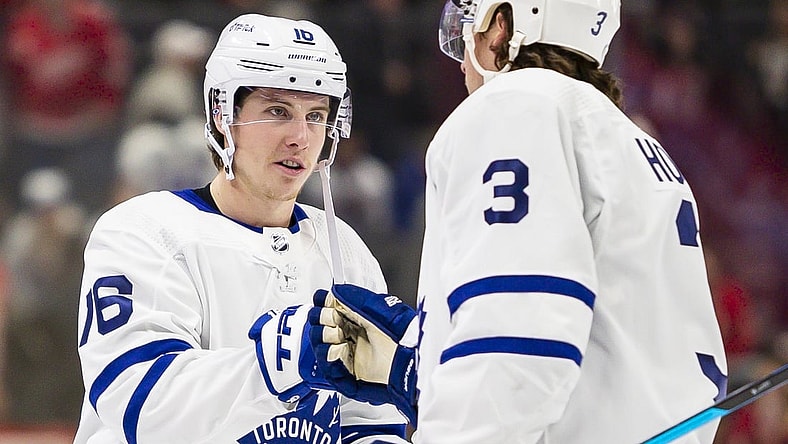 Feb 26, 2022; Detroit, Michigan, USA; Toronto Maple Leafs right wing Mitchell Marner (16) celebrates with defenseman Justin Holl (3) after the game against the Detroit Red Wings at Little Caesars Arena. Mandatory Credit: Raj Mehta-USA TODAY Sports