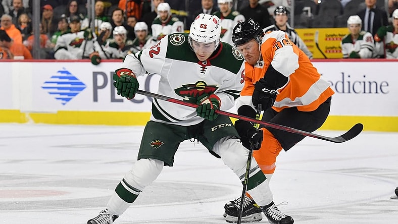 Mar 3, 2022; Philadelphia, Pennsylvania, USA; Minnesota Wild center Connor Dewar (52) and Philadelphia Flyers center Patrick Brown (38) battle for the puck during the first period at Wells Fargo Center. Mandatory Credit: Eric Hartline-USA TODAY Sports