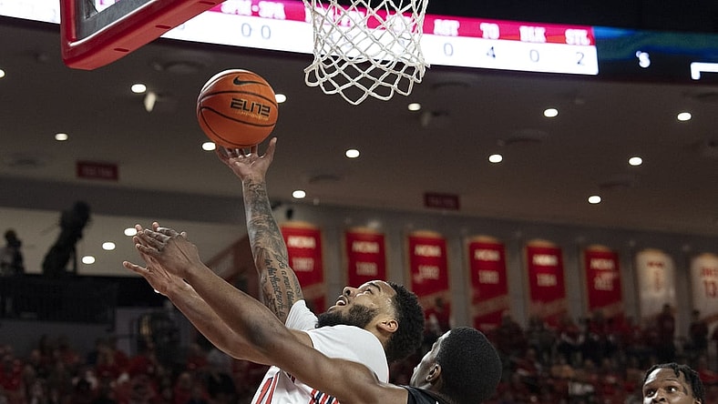 Mar 3, 2022; Houston, Texas, USA;  Houston Cougars guard Kyler Edwards (11) shoots against Temple Owls guard Hysier Miller (4) in the first half at Fertitta Center. Mandatory Credit: Thomas Shea-USA TODAY Sports