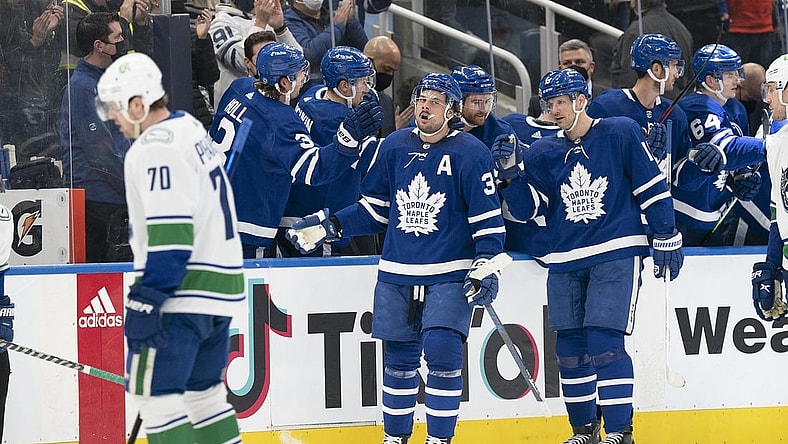 Mar 5, 2022; Toronto, Ontario, CAN; Toronto Maple Leafs center Auston Matthews (34) celebrates at the bench after scoring a goal during the second period against the Vancouver Canucks at Scotiabank Arena. Mandatory Credit: Nick Turchiaro-USA TODAY Sports