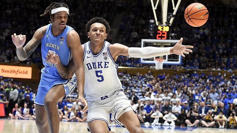 Mar 5, 2022; Durham, North Carolina, USA; Duke Blue Devils forward Paolo Banchero (5) loses the ball out of bounds as he drives to the basket with North Carolina Tar Heels forward Armando Bacot (5) defending during the second half  at Cameron Indoor Stadium.  The Tar Heels won 94-81. Mandatory Credit: Rob Kinnan-USA TODAY Sports