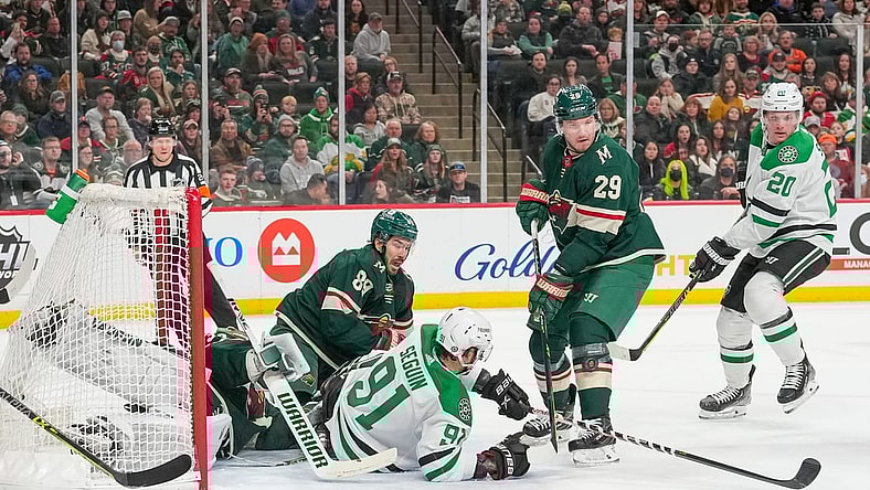 Mar 6, 2022; Saint Paul, Minnesota, USA; Minnesota Wild center Frederick Gaudreau (89), goaltender Kaapo Kahkonen (34) and Dallas Stars center Tyler Seguin (91) watch the puck go by Minnesota Wild defenseman Dmitry Kulikov (29) on its way to the back of the net to tie the game in the first period at Xcel Energy Center. Mandatory Credit: Matt Blewett-USA TODAY Sports