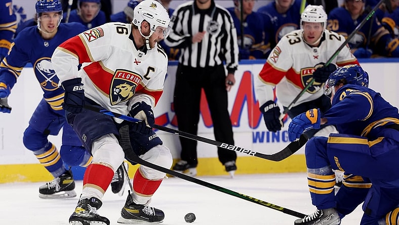 Mar 7, 2022; Buffalo, New York, USA;  Florida Panthers center Aleksander Barkov (16) looks to control the puck as Buffalo Sabres left wing Victor Olofsson (71) tries to defend during the first period at KeyBank Center. Mandatory Credit: Timothy T. Ludwig-USA TODAY Sports