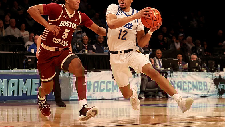 Mar 8, 2022; Brooklyn, NY, USA; Pittsburgh Panthers guard Ithiel Horton (12) drives to the basket against Boston College Eagles guard DeMarr Langford Jr. (5) during the first half at Barclays Center. Mandatory Credit: Brad Penner-USA TODAY Sports