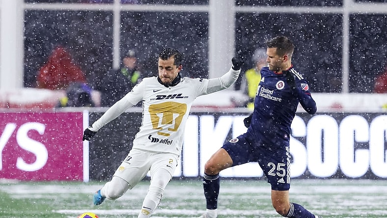 Mar 9, 2022; Foxborough, Massachusetts, USA; Pumas UNAM defender Alan Mozo (2) passes the ball defended by New England Revolution midfielder Arnor Traustason (25) during the first half at Gillette Stadium. Mandatory Credit: Paul Rutherford-USA TODAY Sports