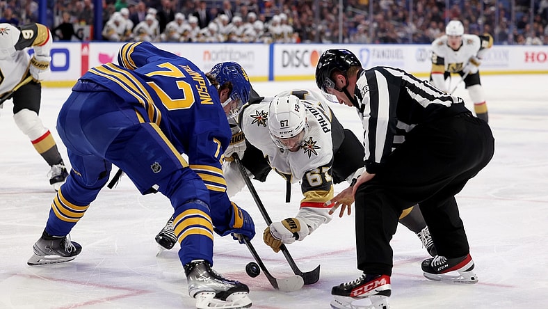 Mar 10, 2022; Buffalo, New York, USA;  NHL linesman Tyson Baker (88) drops the puck for a face-off between Buffalo Sabres right wing Tage Thompson (72) and Vegas Golden Knights left wing Max Pacioretty (67) during the first period at KeyBank Center. Mandatory Credit: Timothy T. Ludwig-USA TODAY Sports
