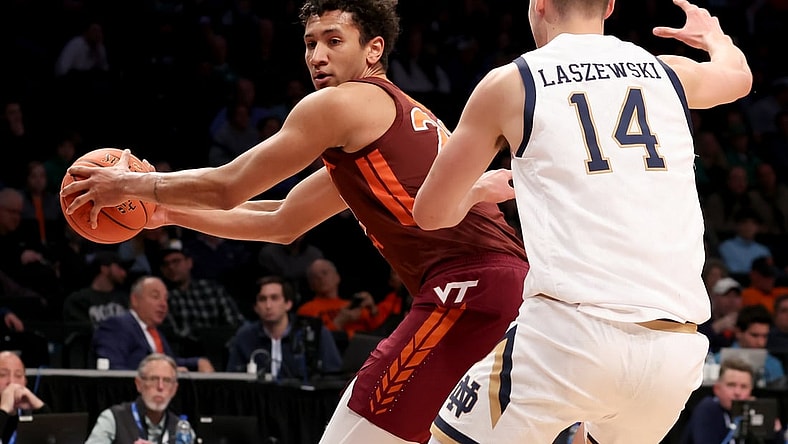 Mar 10, 2022; Brooklyn, NY, USA; Virginia Tech Hokies forward Keve Aluma (22) controls the ball against Notre Dame Fighting Irish forward Nate Laszewski (14) during the first half at Barclays Center. Mandatory Credit: Brad Penner-USA TODAY Sports