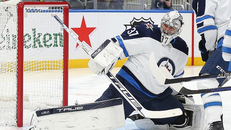 Mar 11, 2022; Elmont, New York, USA; Winnipeg Jets goaltender Connor Hellebuyck (37) makes a save against the New York Islanders during the second period at UBS Arena. Mandatory Credit: Andy Marlin-USA TODAY Sports