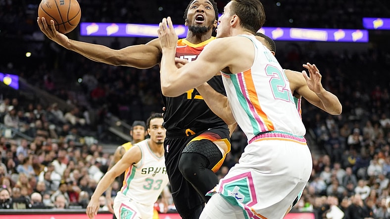 Mar 11, 2022; San Antonio, Texas, USA; Utah Jazz guard Donovan Mitchell drives to the basket while defended by shoots over San Antonio Spurs forward Zach Collins (23) during the first half at AT&T Center. Mandatory Credit: Scott Wachter-USA TODAY Sports