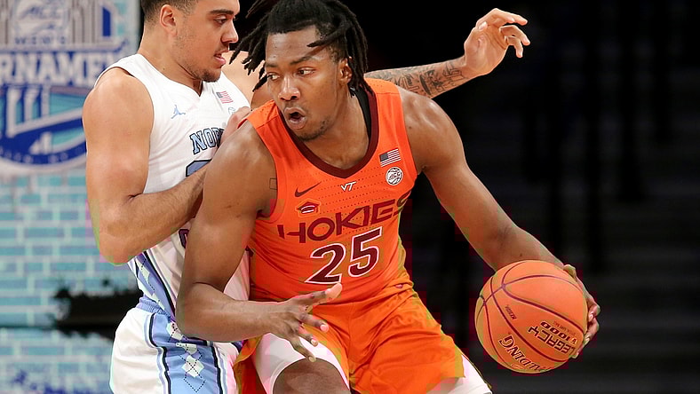 Mar 11, 2022; Brooklyn, NY, USA; Virginia Tech Hokies forward Justyn Mutts (25) controls the ball against North Carolina Tar Heels forward Justin McKoy (22) during the first half of the ACC Tournament semifinal game at Barclays Center. Mandatory Credit: Brad Penner-USA TODAY Sports