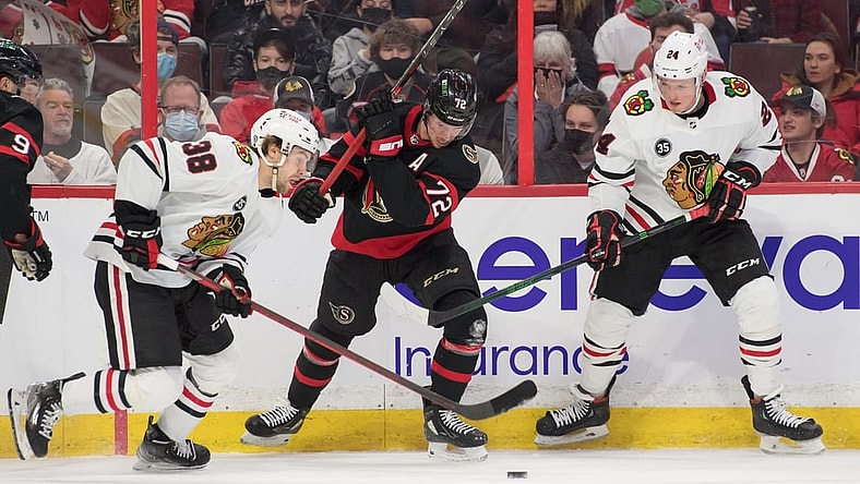 Mar 12, 2022; Ottawa, Ontario, CAN; Chicago Blackhawks left wing Brandon Hagel (38) moves the puck past Ottawa Senators defenseman Thomas Chabot (72) in the first period at the Canadian Tire Centre. Mandatory Credit: Marc DesRosiers-USA TODAY Sports
