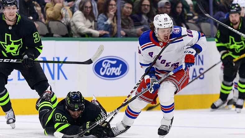 Mar 12, 2022; Dallas, Texas, USA; New York Rangers left wing Artemi Panarin (10) skates with the puck past Dallas Stars center Tyler Seguin (91) during the first period at the American Airlines Center. Mandatory Credit: Jerome Miron-USA TODAY Sports