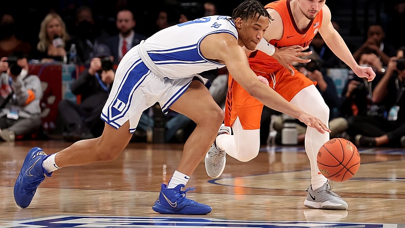 Mar 12, 2022; Brooklyn, NY, USA; Duke Blue Devils forward Wendell Moore Jr. (0) and Virginia Tech Hokies guard Hunter Cattoor (0) fight for a loose ball during the first half of the ACC Men's Basketball Tournament final at Barclays Center. Mandatory Credit: Brad Penner-USA TODAY Sports