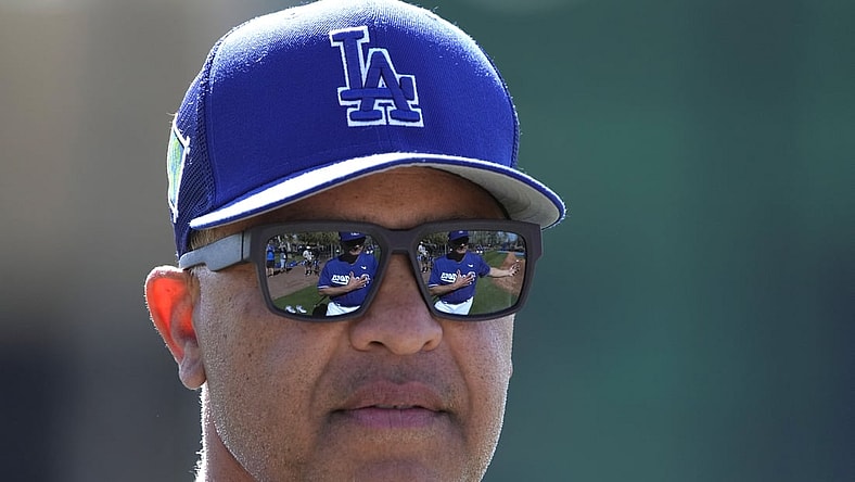 Mar 15, 2022; Glendale, AZ, USA; Los Angeles Dodgers manager Dave Roberts (30) watches warmups during spring training camp at Camelback Ranch. Mandatory Credit: Rick Scuteri-USA TODAY Sports