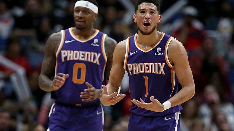 Mar 15, 2022; New Orleans, Louisiana, USA; Phoenix Suns guard Devin Booker (1) and forward Torrey Craig (0) gesture after a call in the first quarter against the New Orleans Pelicans at the Smoothie King Center. Mandatory Credit: Chuck Cook-USA TODAY Sports