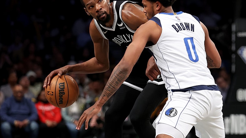 Mar 16, 2022; Brooklyn, New York, USA; Brooklyn Nets forward Kevin Durant (7) controls the ball against Dallas Mavericks forward Sterling Brown (0) during the third quarter at Barclays Center. Mandatory Credit: Brad Penner-USA TODAY Sports