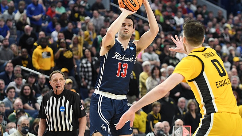 Mar 17, 2022; Buffalo, NY, USA; Richmond Spiders guard Connor Crabtree (13) shoots the ball against Iowa Hawkeyes forward Filip Rebraca (0) in the second half during the first round of the 2022 NCAA Tournament at KeyBank Center. Mandatory Credit: Mark Konezny-USA TODAY Sports
