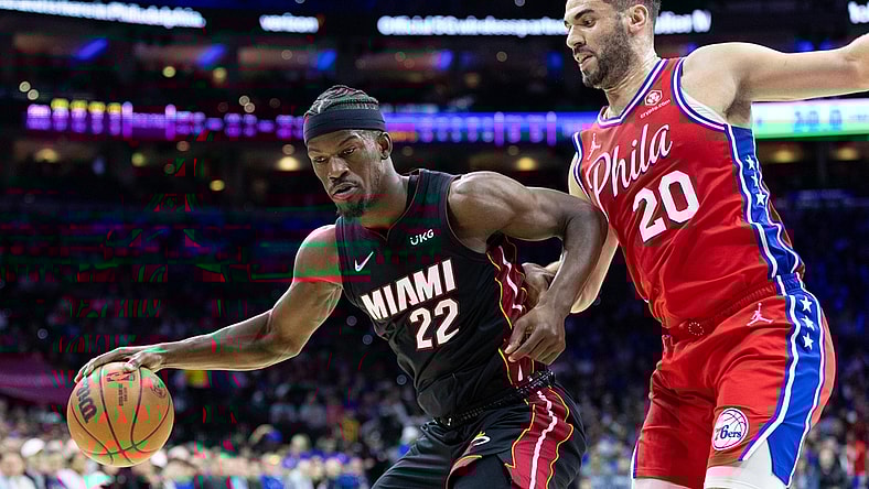 Mar 21, 2022; Philadelphia, Pennsylvania, USA; Miami Heat forward Jimmy Butler (22) dribbles the ball against Philadelphia 76ers forward Georges Niang (20) during the second quarter at Wells Fargo Center. Mandatory Credit: Bill Streicher-USA TODAY Sports