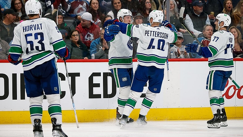 Mar 23, 2022; Denver, Colorado, USA; Vancouver Canucks right wing Brock Boeser (6) celebrates his goal with center Elias Pettersson (40) and defenseman Brad Hunt (77) and center Bo Horvat (53) in the third period against the Colorado Avalanche at Ball Arena. Mandatory Credit: Isaiah J. Downing-USA TODAY Sports