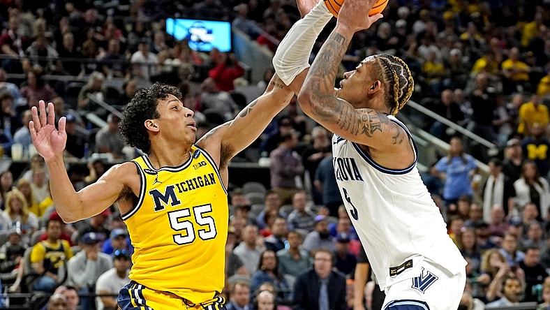 Mar 24, 2022; San Antonio, TX, USA; Villanova Wildcats guard Justin Moore (5) drives to the basket against Michigan Wolverines guard Eli Brooks (55) in the semifinals of the South regional of the men's college basketball NCAA Tournament at AT&T Center. Mandatory Credit: Scott Wachter-USA TODAY Sports