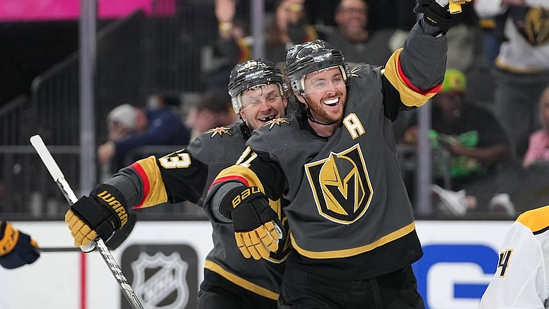 Mar 24, 2022; Las Vegas, Nevada, USA; Vegas Golden Knights right wing Evgenii Dadonov (63) and center Jonathan Marchessault (81) celebrate after Vegas Golden Knights center Jack Eichel (not pictured) scored a goal against the Nashville Predators during the second period at T-Mobile Arena. Mandatory Credit: Stephen R. Sylvanie-USA TODAY Sports