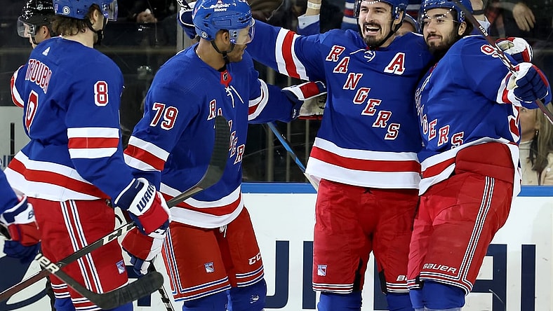 Mar 25, 2022; New York, New York, USA; New York Rangers left wing Chris Kreider (20) celebrates his goal against the Pittsburgh Penguins with defenseman Jacob Trouba (8) and defenseman K'Andre Miller (79) and center Mika Zibanejad (93) during the first period at Madison Square Garden. Mandatory Credit: Brad Penner-USA TODAY Sports