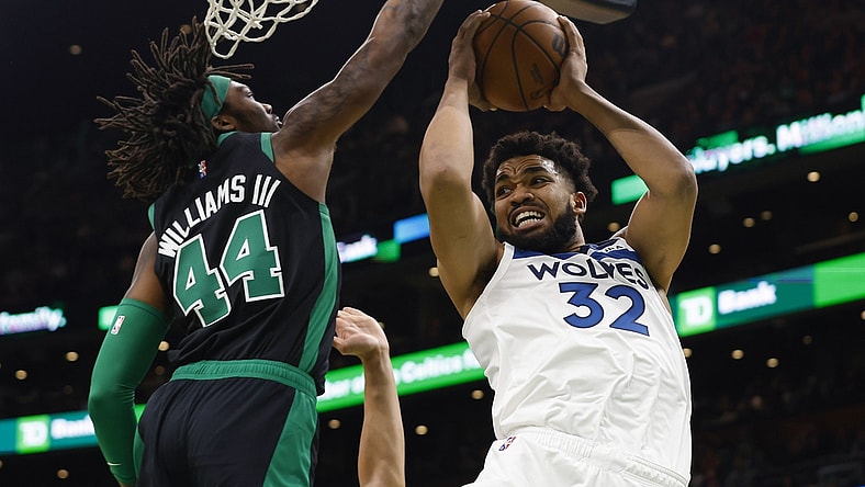 Mar 27, 2022; Boston, Massachusetts, USA; Minnesota Timberwolves center Karl-Anthony Towns (32) looks for a way around Boston Celtics center Robert Williams III (44) during the first quarter at TD Garden. Mandatory Credit: Winslow Townson-USA TODAY Sports