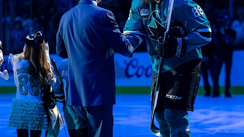 Jan 12, 2019; San Jose, CA, USA; San Jose Sharks general manager Doug Wilson congratulates San Jose Sharks defenseman Brent Burns (88) in a ceremony commemorating Burns playing 1000 games before the game against the Ottawa Senators  at SAP Center at San Jose. Mandatory Credit: John Hefti-USA TODAY Sports