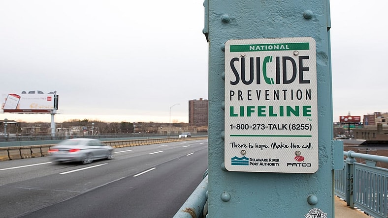 A sign for the National Suicide Prevention Hotline on the Camden side of the Benjamin Franklin Bridge.