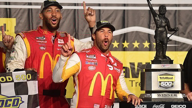 Oct 4, 2021; Talladega, Alabama, USA; NASCAR Cup Series driver Bubba Wallace (23) celebrates with the trophy after winning the YellaWood 500 at Talladega Superspeedway. Mandatory Credit: Adam Hagy-USA TODAY Sports