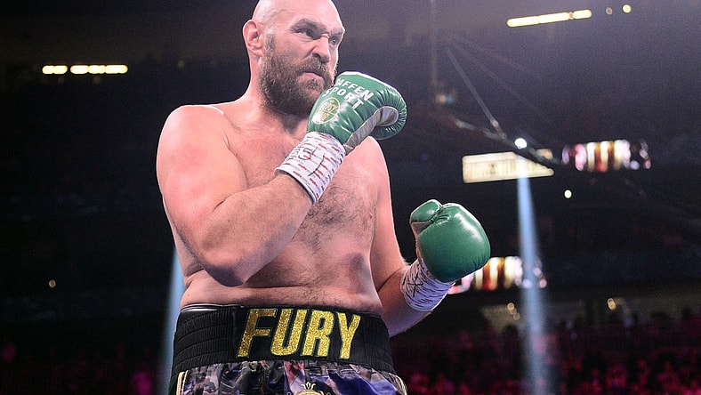 Oct 9, 2021; Las Vegas, Nevada, USA; Deontay Wilder (red/black trunks) and Tyson Fury (black/gold trunks) box during their WBC/Lineal heavyweight championship boxing match at T-Mobile Arena. Mandatory Credit: Joe Camporeale-USA TODAY Sports