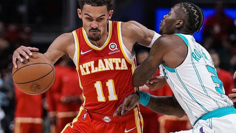 Nov 20, 2021; Atlanta, Georgia, USA; Atlanta Hawks guard Trae Young (11) dribbles against Charlotte Hornets guard Terry Rozier (3) during the second half at State Farm Arena. Mandatory Credit: Dale Zanine-USA TODAY Sports