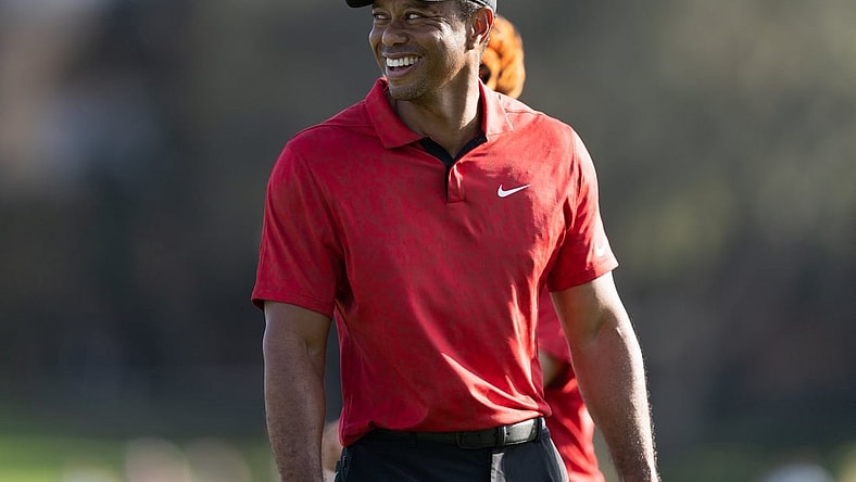 Dec 19, 2021; Orlando, Florida, USA; Tiger Woods smiling as he walks off the 17th green during the final round of the PNC Championship golf tournament at Grande Lakes Orlando Course. Mandatory Credit: Jeremy Reper-USA TODAY Sports