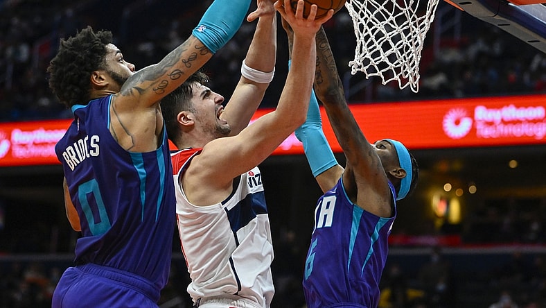 Jan 3, 2022; Washington, District of Columbia, USA; Charlotte Hornets forward Miles Bridges (0) blocks the shot of Washington Wizards forward Deni Avdija (9) during the second half at Capital One Arena. Mandatory Credit: Brad Mills-USA TODAY Sports