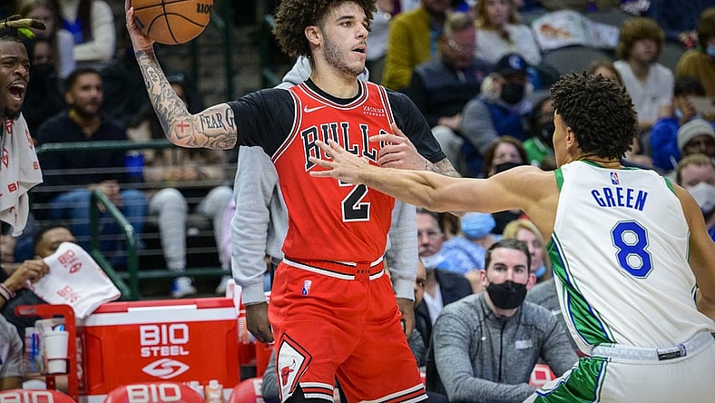 Jan 9, 2022; Dallas, Texas, USA; Chicago Bulls guard Lonzo Ball (2) looks to pass the ball by Dallas Mavericks guard Josh Green (8) during the second quarter at the American Airlines Center. Mandatory Credit: Jerome Miron-USA TODAY Sports
