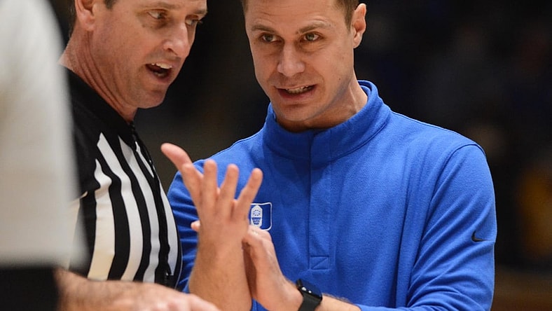 Feb 15, 2022; Durham, North Carolina, USA; Duke Blue Devils associate head coach Jon Scheyer (right) talks with and official during the second half at Cameron Indoor Stadium. The Blue Devils won 76-74. Mandatory Credit: Rob Kinnan-USA TODAY Sports