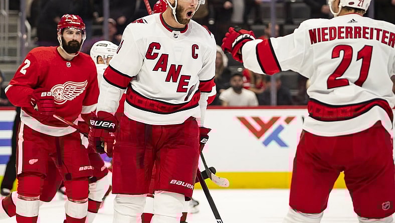Mar 1, 2022; Detroit, Michigan, USA; Carolina Hurricanes center Jordan Staal (11) celebrates with right wing Nino Niederreiter (21) after scoring a goal during the third period against the Detroit Red Wings at Little Caesars Arena. Mandatory Credit: Raj Mehta-USA TODAY Sports