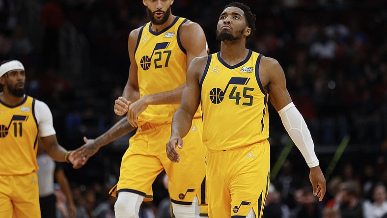 Mar 2, 2022; Houston, Texas, USA; Utah Jazz guard Donovan Mitchell (45) and center Rudy Gobert (27) react after a play during the third quarter against the Houston Rockets at Toyota Center. Mandatory Credit: Troy Taormina-USA TODAY Sports