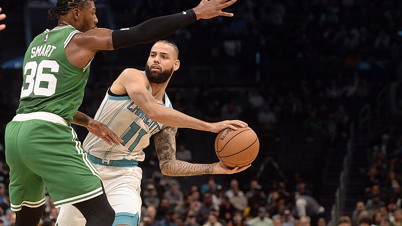 Mar 9, 2022; Charlotte, North Carolina, USA;  Charlotte Hornets guard forward Cody Martin (11) looks to pass as he is defended by Boston Celtics guard Marcus Smart (36)  during the first half at the Spectrum Center. Mandatory Credit: Sam Sharpe-USA TODAY Sports
