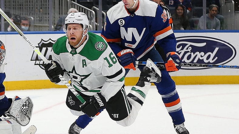 Mar 19, 2022; Elmont, New York, USA; Dallas Stars center Joe Pavelski (16) is checked from behind by New York Islanders defenseman Zdeno Chara (33) during the third period at UBS Arena. Mandatory Credit: Andy Marlin-USA TODAY Sports