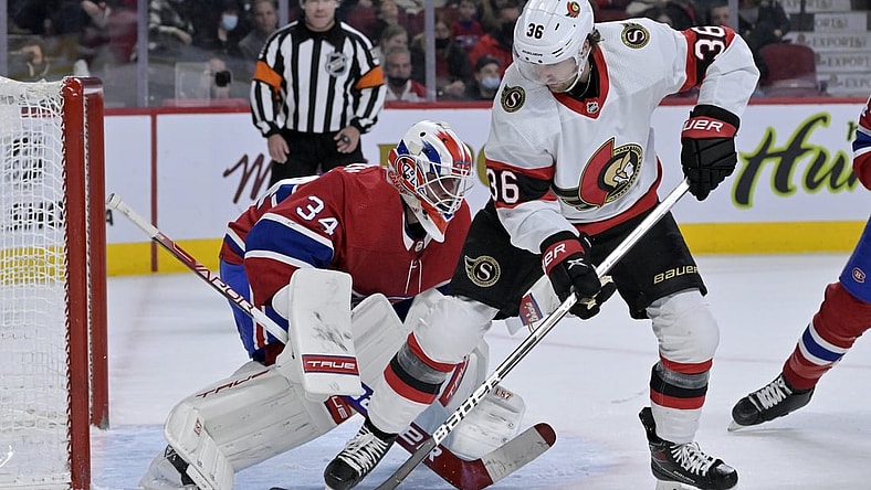 Mar 19, 2022; Montreal, Quebec, CAN; Montreal Canadiens goalie Jake Allen (34) stops Ottawa Senators forward Colin White (36) during the first period at the Bell Centre. Mandatory Credit: Eric Bolte-USA TODAY Sports