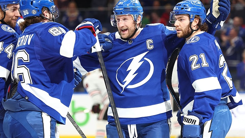 Apr 1, 2022; Tampa, Florida, USA;Tampa Bay Lightning center Steven Stamkos (91) is congratulated by defenseman Victor Hedman (77), center Brayden Point (21), left wing Pierre-Edouard Bellemare (41) and right wing Nikita Kucherov (86) after a goal during the first period against the Chicago Blackhawks at Amalie Arena. Mandatory Credit: Kim Klement-USA TODAY Sports